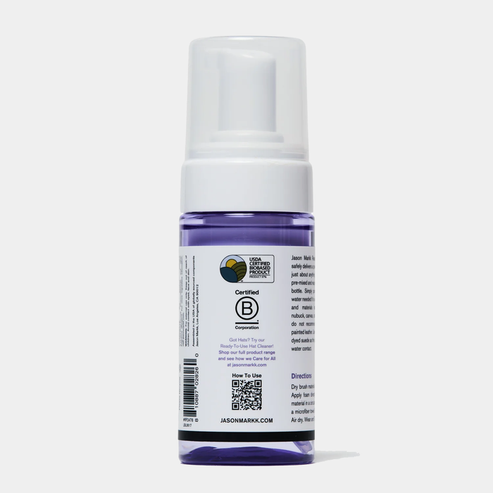 Jason Markk Complete Clean Kit cleaning bottle with purple liquid and white pump top, back view showing label and instructions.