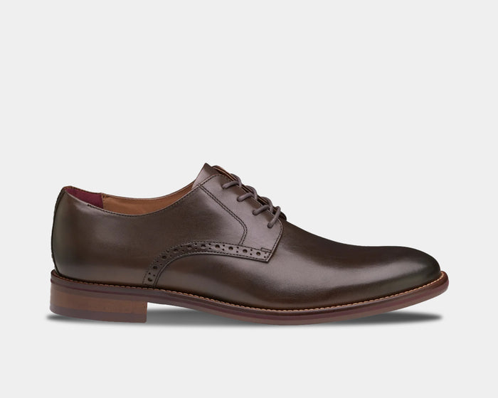 Johnston & Murphy Conard 2.0 Plain Toe dress shoes in dark brown leather with brogue detailing and woodgrain sole, side view.