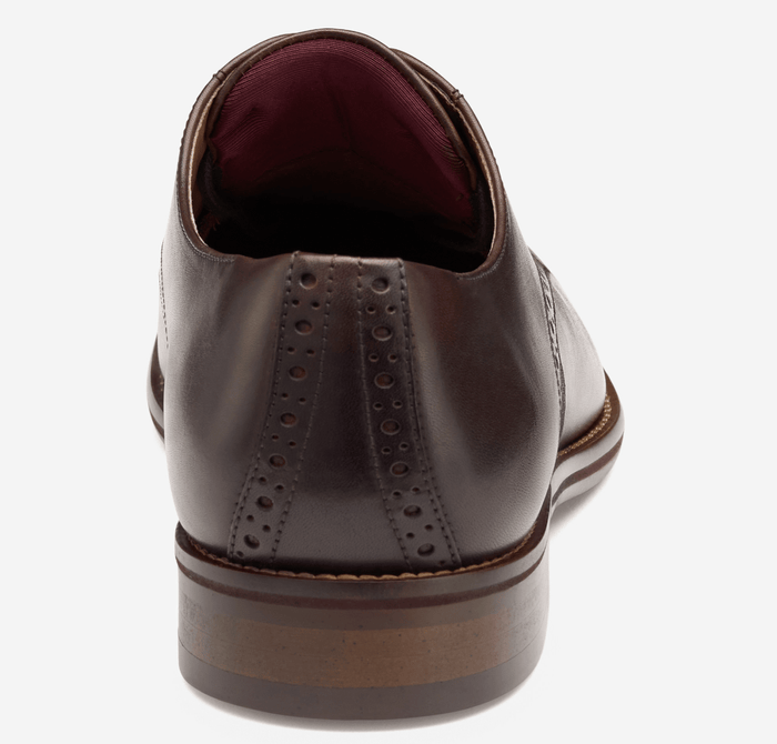 Johnston & Murphy Conard 2.0 Plain Toe dress shoe in dark brown leather with brogue details, back view showcasing layered heel design.
