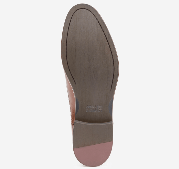 Johnston & Murphy Conard Cap Toe dress shoe outsole showing brown leather sole with etched branding and stitched detailing.
