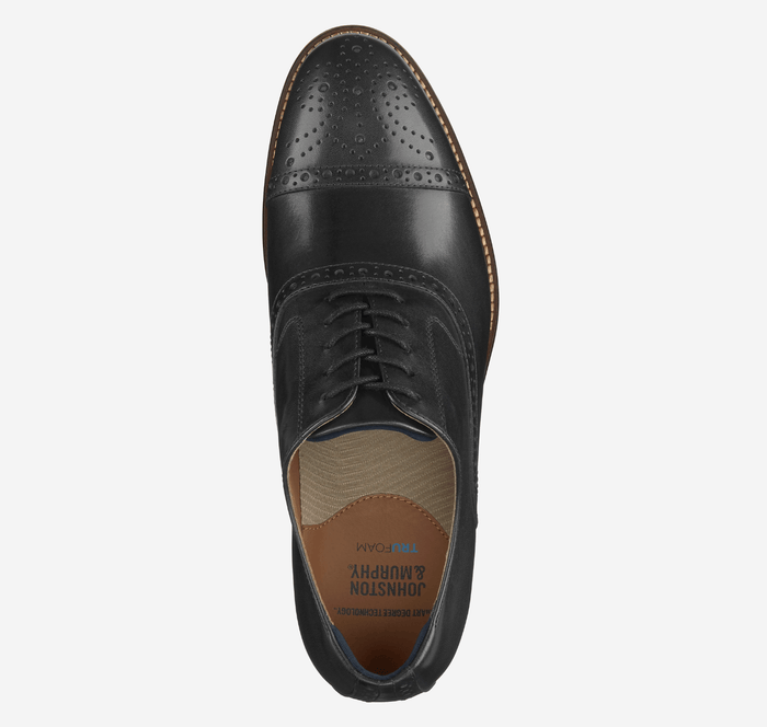 Johnston & Murphy Conard Cap Toe dress shoe, black leather with brogue perforations and tan lining, top view.
