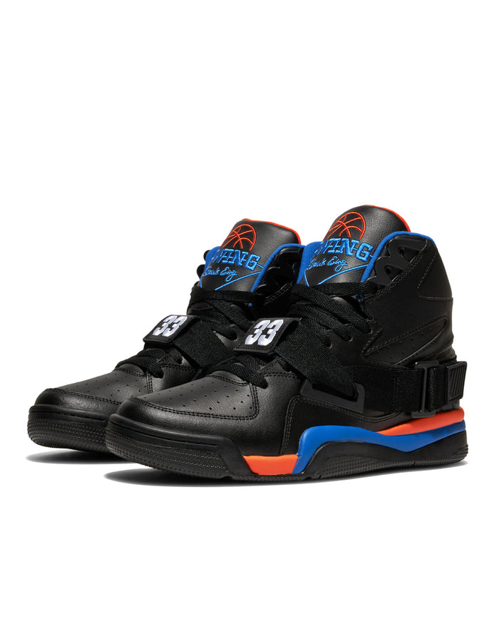 Ewing Athletics CONCEPT OG PE basketball shoes in black with orange and blue accents, leather upper, strap detailing, and perforated toe box, front angle view.