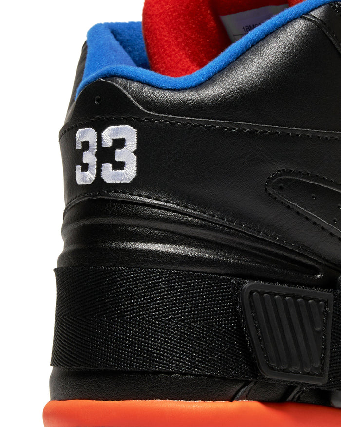 Ewing Athletics CONCEPT OG PE sneakers in black leather with embroidered "33," blue and red collar, and orange midsole, back view.