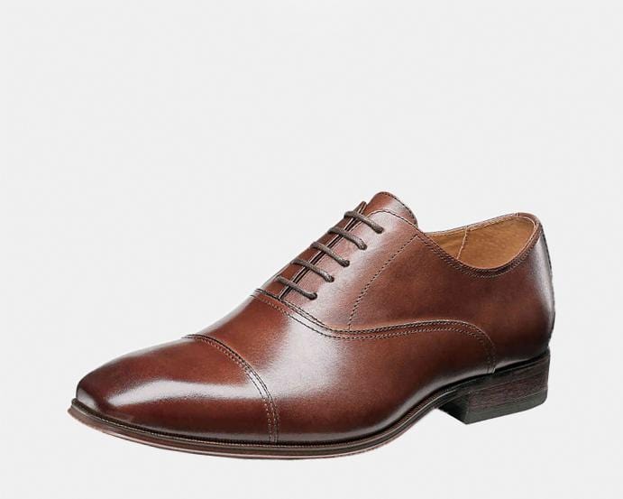 Florsheim Corbetta dress shoe in polished brown leather with cap-toe design and lace-up closure, side angle view