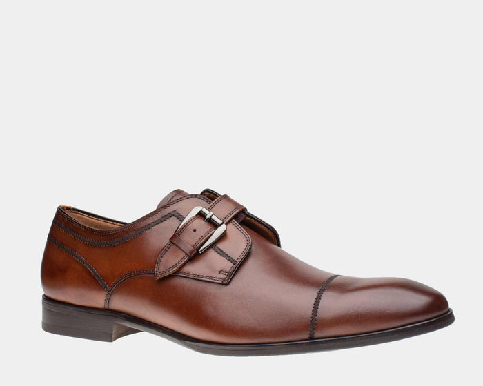 Steve Madden Covet dress shoes in brown leather with monk strap buckle and stitched cap toe detail, side view.