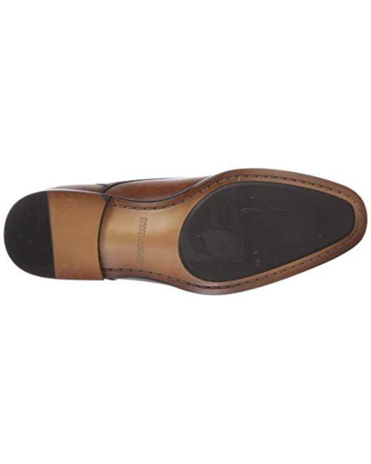 Steve Madden Covet dress shoes sole view showing black rubber outsole and stitched detailing on brown leather.
