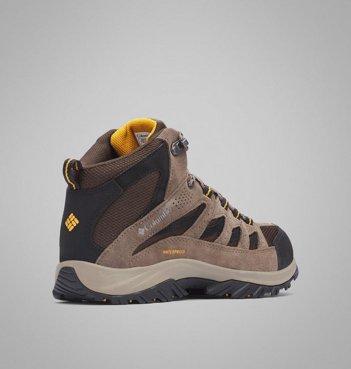 Columbia Crestwood Mid Waterproof hiking boots in brown with black and yellow accents, featuring suede and mesh upper, side view.