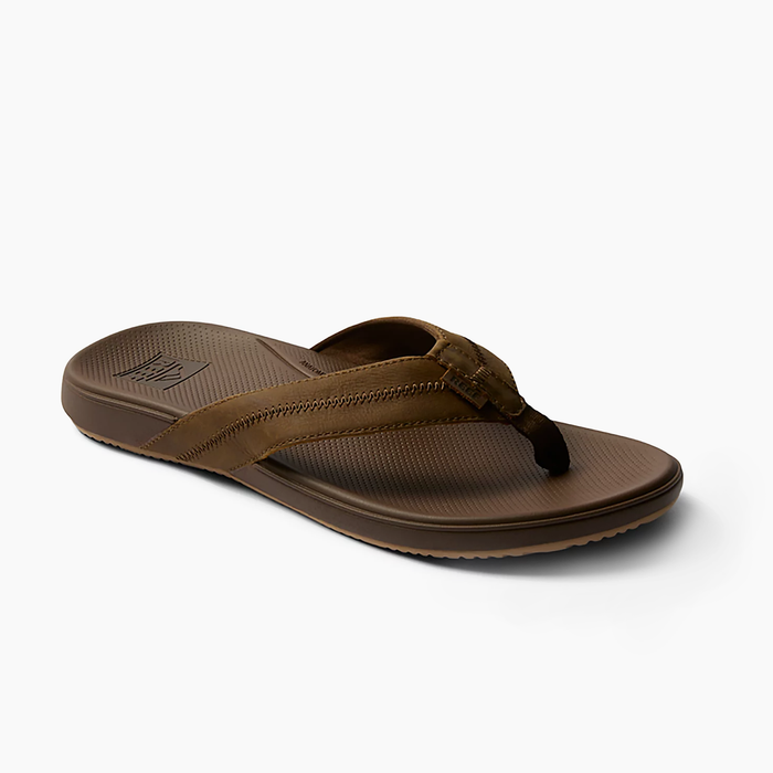 Reef Cushion Phantom 2.0 LE sandals in brown with leather straps, cushioned footbed, and textured outsole, angled side view.