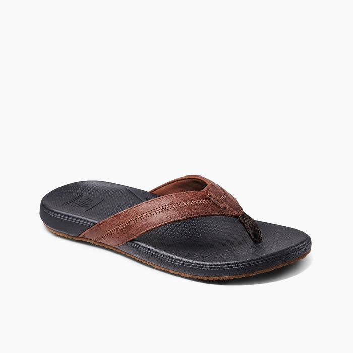 Reef Cushion Phantom 2.0 LE sandals with brown leather straps and textured black footbed, angled front and side view.