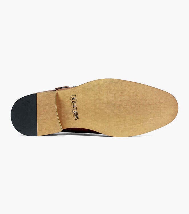 Stacy Adams Desmond Cap Toe Monk Strap shoe outsole in tan with stamped logo and black heel, sole view.