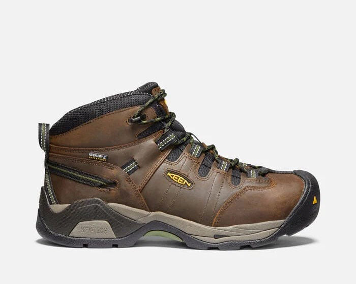 Keen Detroit XT Steel Toe Mid Waterproof Boots in brown leather and black mesh with green accents, side view showing rugged outsole and steel toe protection.