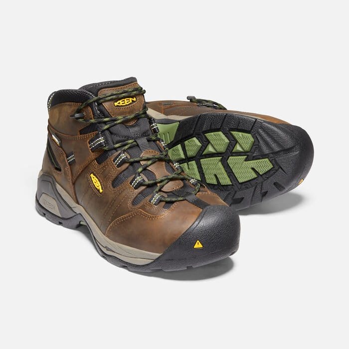 Keen Detroit XT Steel Toe Mid Waterproof Boots in brown leather with black toe caps, green outsole, and secure lace system, angled view.