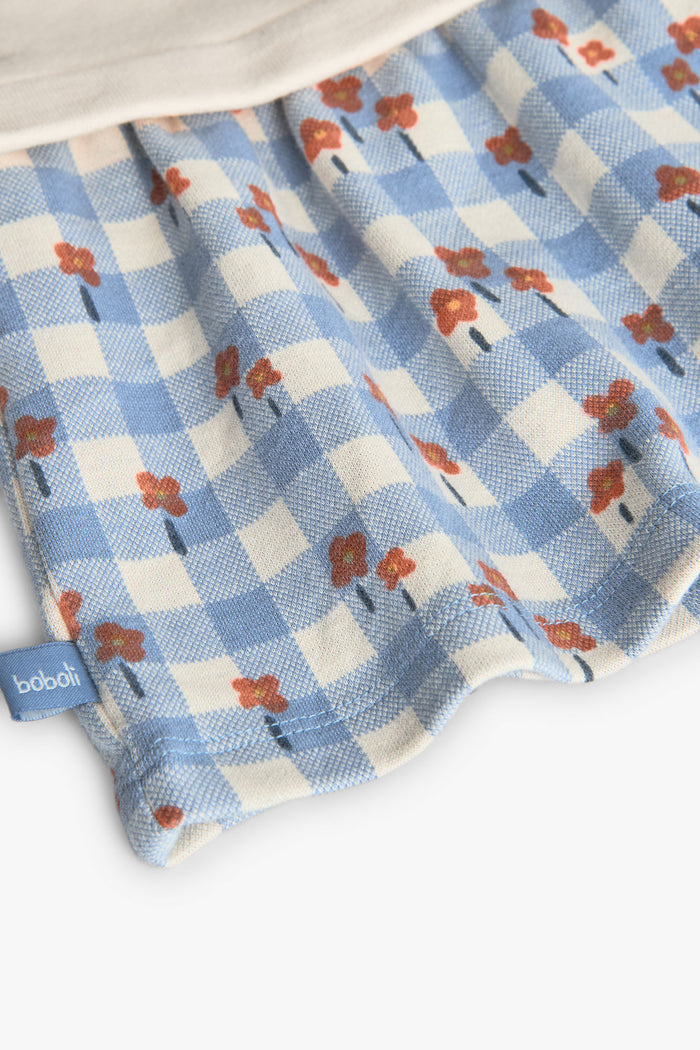 Fabric with blue checkered pattern and red floral design, featuring the brand 'Bubba'.