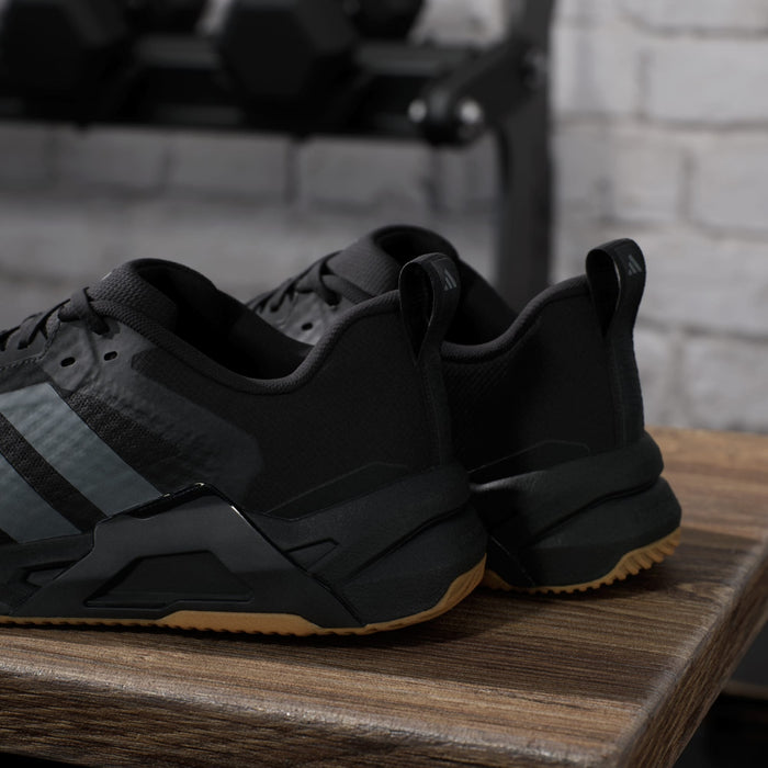 Adidas Dropset Control Trainer shoes in black with gray accents and gum outsole, back view showing pull tabs and heel details.