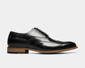 Stacy Adams Dunbar Wingtip Oxford dress shoes in black leather with brogue details and wooden sole, side view.