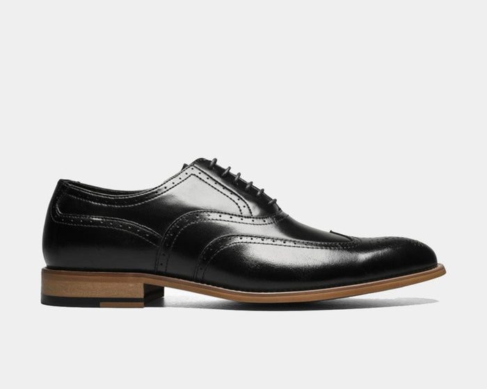Stacy Adams Dunbar Wingtip Oxford dress shoes in black leather with brogue details and wooden sole, side view.