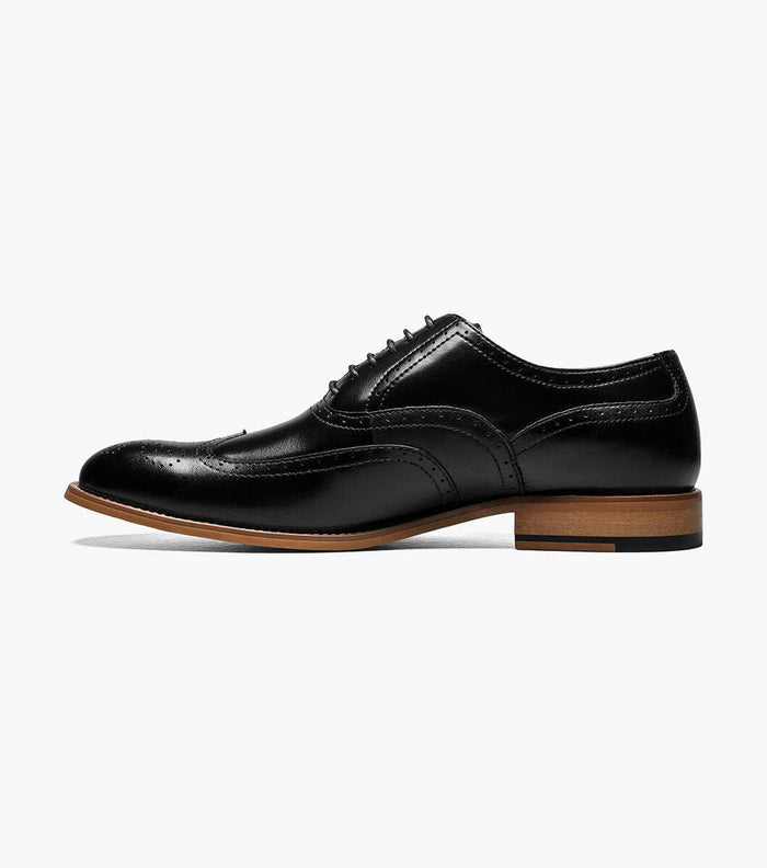 Stacy Adams Dunbar Wingtip Oxford dress shoes in black leather with brogue detailing and stacked wooden heel, side view.