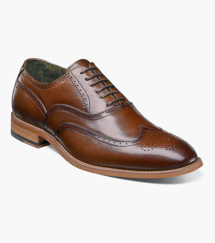 Stacy Adams Dunbar Wingtip Oxford dress shoe in polished brown leather with brogue detailing and stacked heel, angled side view.