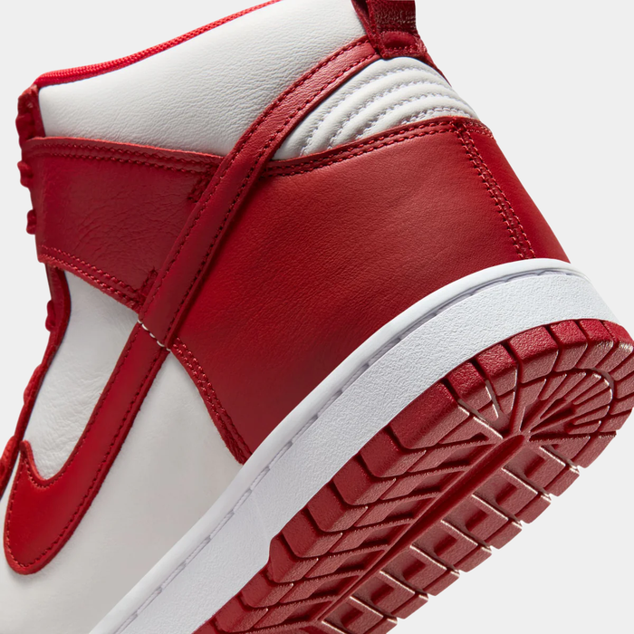Nike Dunk High Retro SE sneakers in red and white leather, close-up showing heel and outsole detailing.