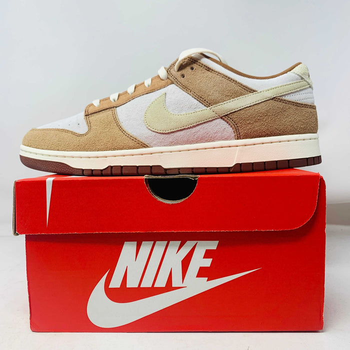 Nike Dunk Low Medium Curry sneakers, brand new, displayed on a red Nike box.