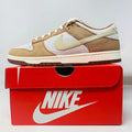 Nike Dunk Low Medium Curry sneakers, brand new, displayed on a red Nike box.