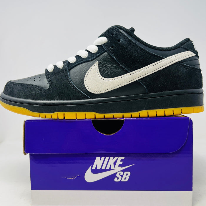 Nike Dunk Low Pro SB sneaker in black, white, and gum colors on a purple Nike SB shoebox, 2025 model