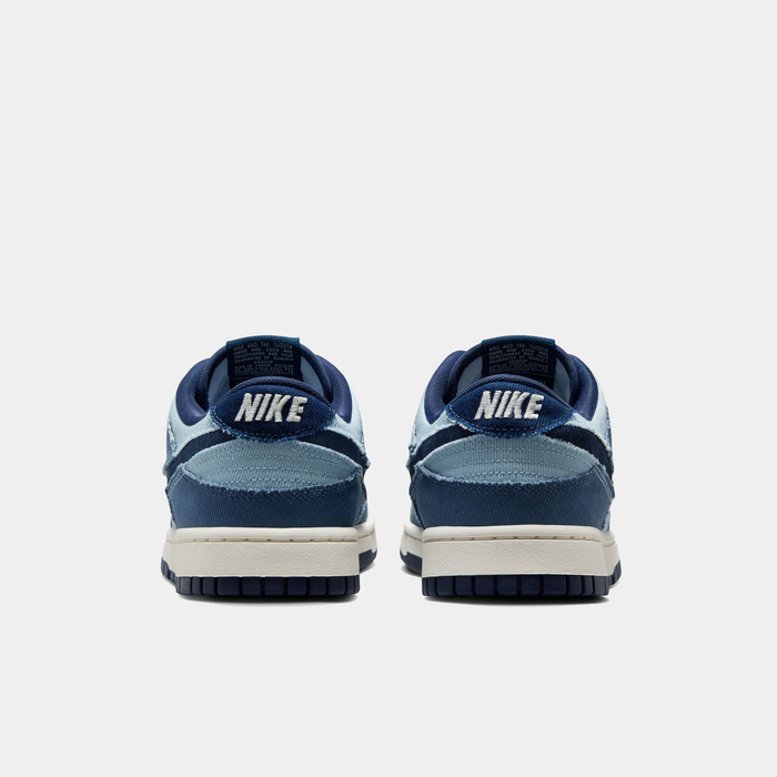 Nike Dunk Low Retro SE sneakers in navy blue and light blue with embroidered Nike branding, back view showing heel details.