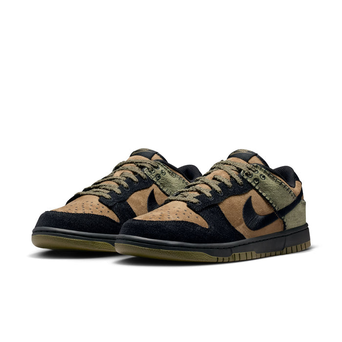 Nike Dunk Low Retro sneakers in black, tan, and olive green suede with perforated toe box, front angle view.