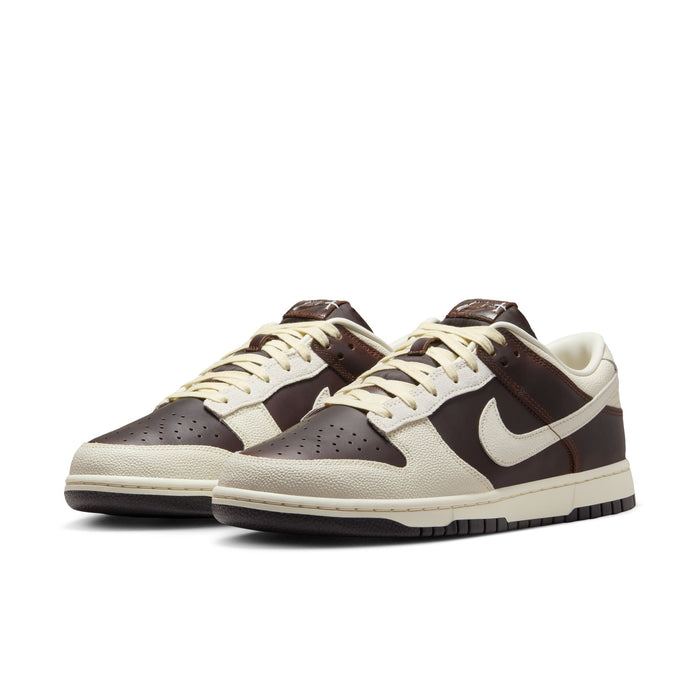 Nike Dunk Low sneakers in brown and cream with textured leather overlays and perforated toe box, front angled view.