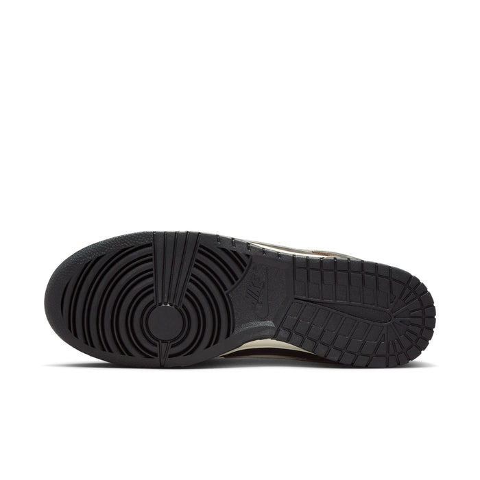 Nike Dunk Low outsole in black rubber with circular tread pattern and embossed branding, sole/bottom view.