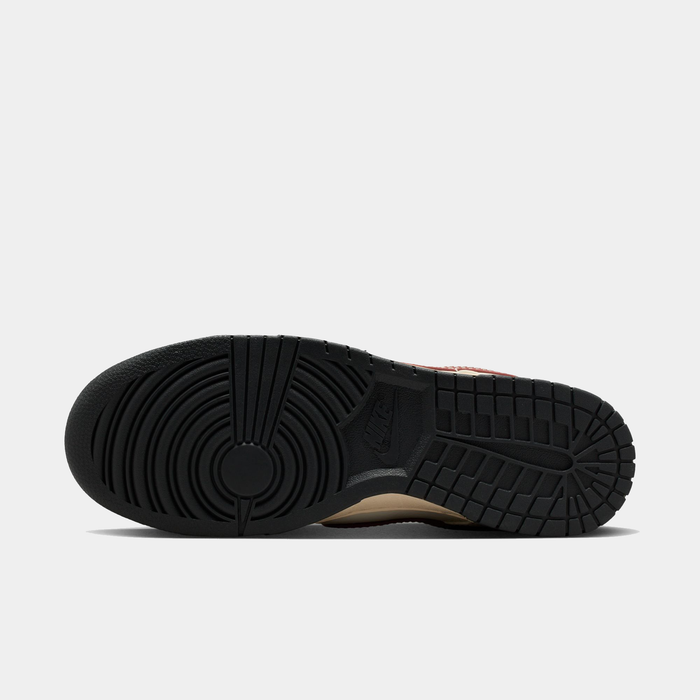 Nike Dunk Low sneaker outsole in black rubber showing circular tread patterns and Nike logo detailing, sole/bottom view.