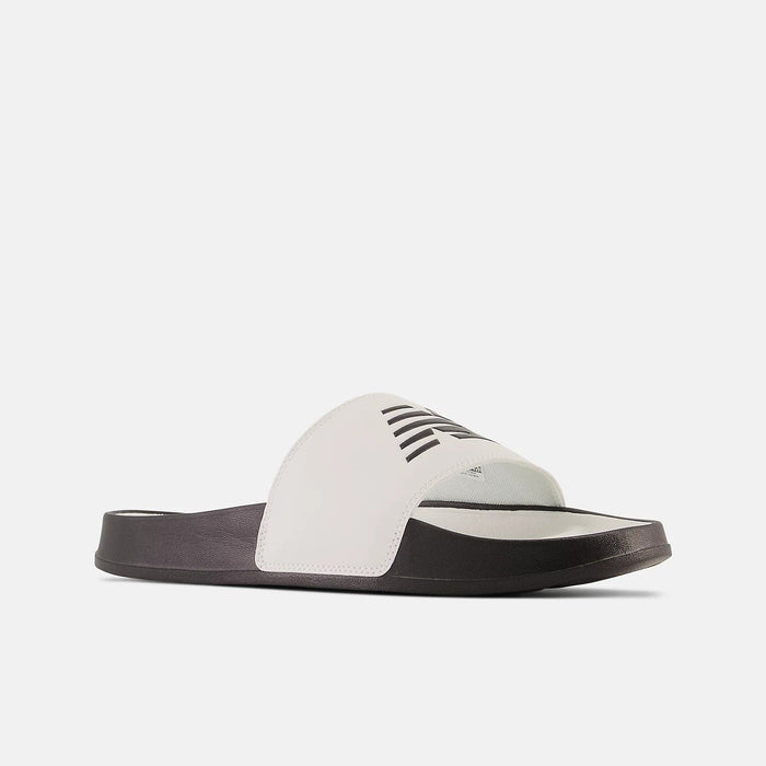 New Balance DynaSoft 200v2 slides in white and black with cushioned sole and wide logo-printed strap, angled side view.