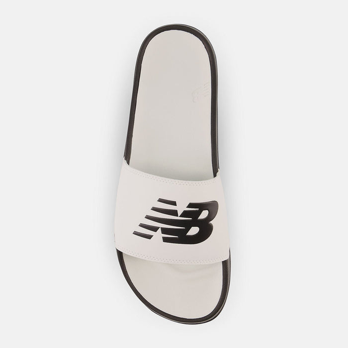 New Balance DynaSoft 200v2 slides with white footbed, black outsole, and wide strap featuring bold black New Balance logo, top view.