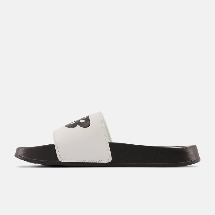 New Balance DynaSoft 200v2 slides in white and black with cushioned sole and logo detail, side view.