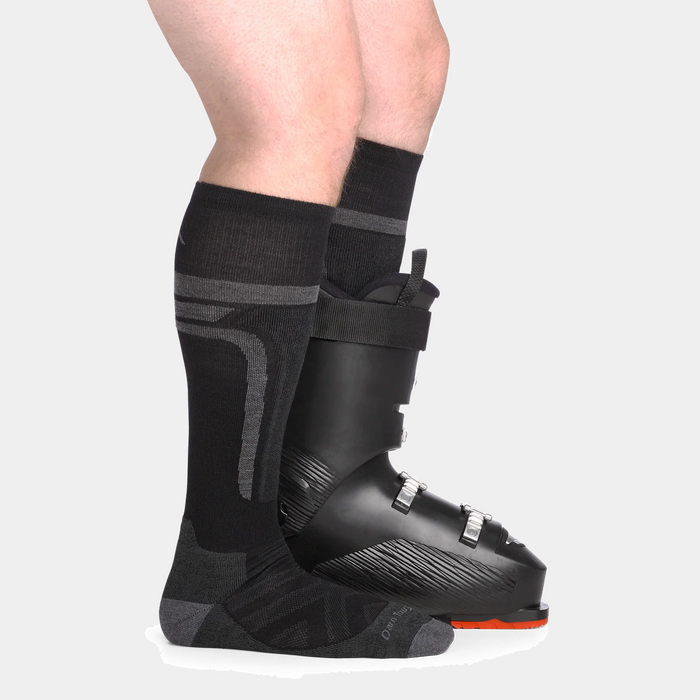 Darn Tough Edge Over-the-Calf Midweight Ski & Snowboard Socks, black with gray patterns, worn with ski boots.