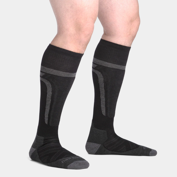 Darn Tough Edge Over-the-Calf Midweight Ski & Snowboard Socks in black and gray with reinforced cushioning, side view worn.