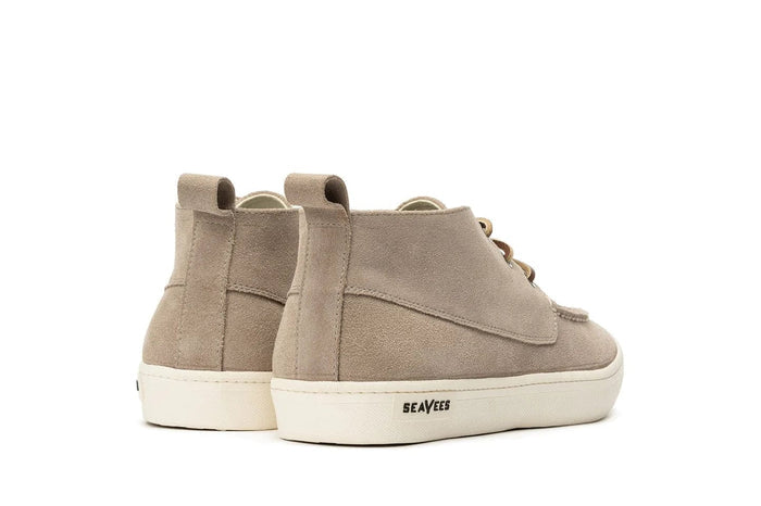 SeaVees El Cap Camp Moc shoes in light tan suede with white rubber outsole, back view showing heel tabs and stitched panel design.