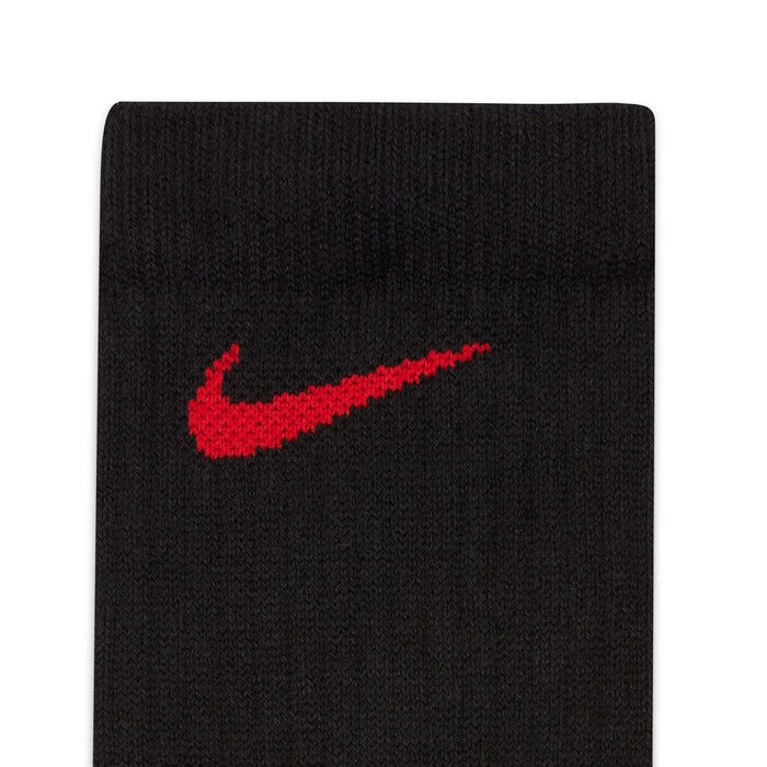 Nike Elite Crew socks in black with red embroidered Nike Swoosh logo, close-up of cuff detail.
