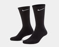 Nike Everyday Cushioned Crew Socks in black with ribbed cuffs and white Nike swoosh logo, angled side view.