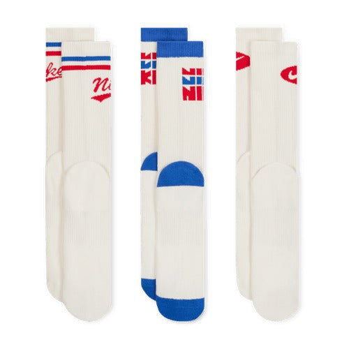 Nike Everyday Plus Crew Socks in white with contrasting red and blue graphic details, front view showing ribbed cuffs and reinforced toe and heel.