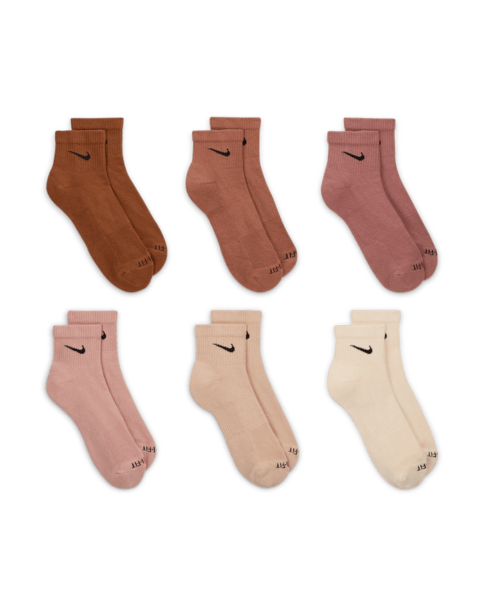 Nike Everyday Plus Cushioned Ankle Socks in assorted earthy tones including brown, tan, pink, and beige with ribbed texture and black logo details, front view.