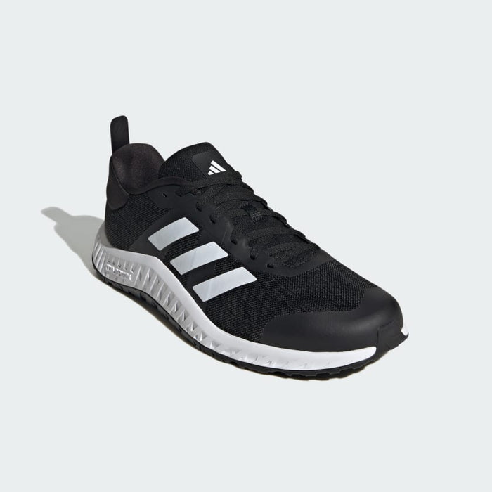 Adidas Everyset Trainer shoes in black with white accents, mesh upper, and textured midsole, front angled view.