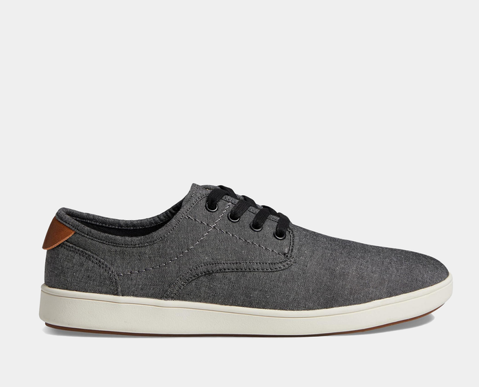 Steve Madden Fenta casual sneakers in gray fabric with black laces, brown heel accent, and white rubber sole, side view.