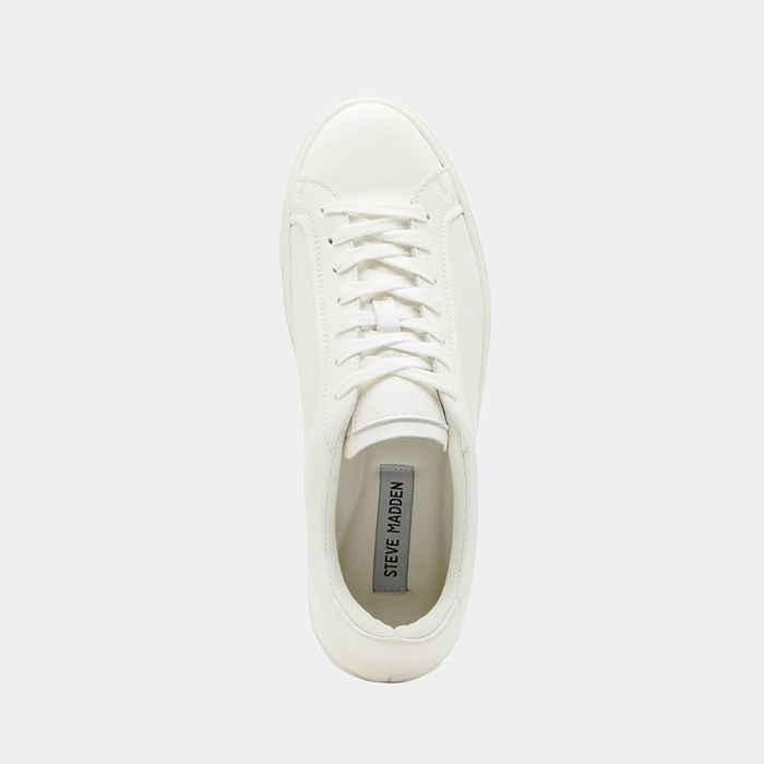 Steve Madden Finneas sneakers in solid white with lace-up closure and sleek leather upper, top view showing branded insole.