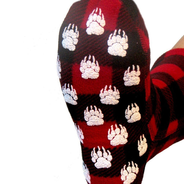 Polar Feet Fleece Socks in red and black plaid with white paw print design, sole view showing anti-slip grip pattern.