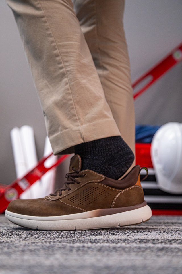 Florsheim Work Fleet Work Comp Toe Oxford shoes in brown leather with perforated sides and cushioned white outsole, side view worn.
