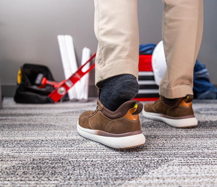Florsheim Work Fleet Work Comp Toe Oxford shoes in brown leather with perforated details and a white outsole, back lifestyle view.