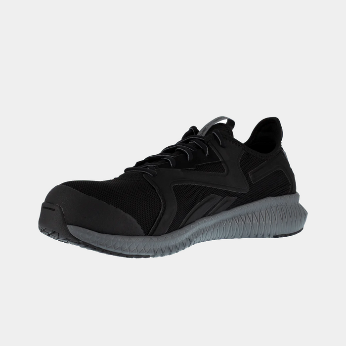 Reebok Work Flexagon 3.0 work shoes in black with a mesh upper, reinforced toe, and gray textured outsole, angled front view.