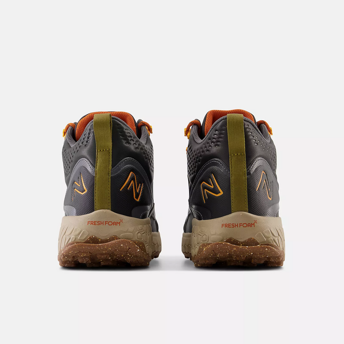 New Balance Foam X Hierro Mid GTX hiking shoes back view in gray and orange with Fresh Foam midsole and textured outsole.