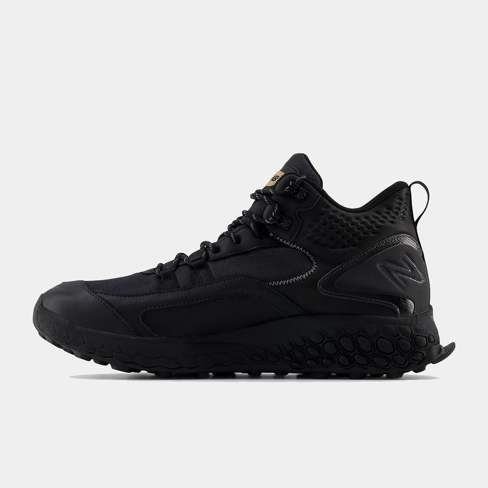 New Balance Foam X Hierro Mid GTX hiking boots in black with Gore-Tex upper and textured outsole, side view.
